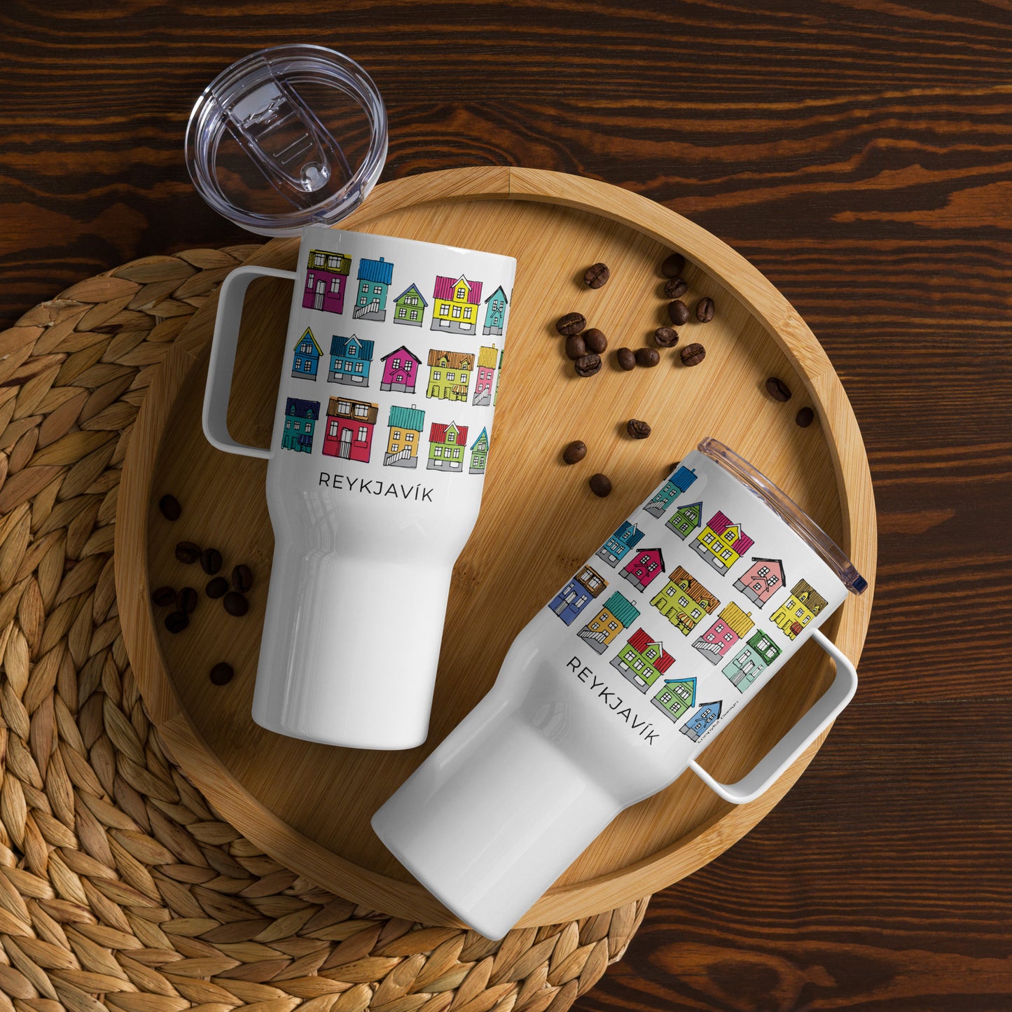 Two white travel mugs with colorful house design and 'Reykjavik' text by Loopyful Design